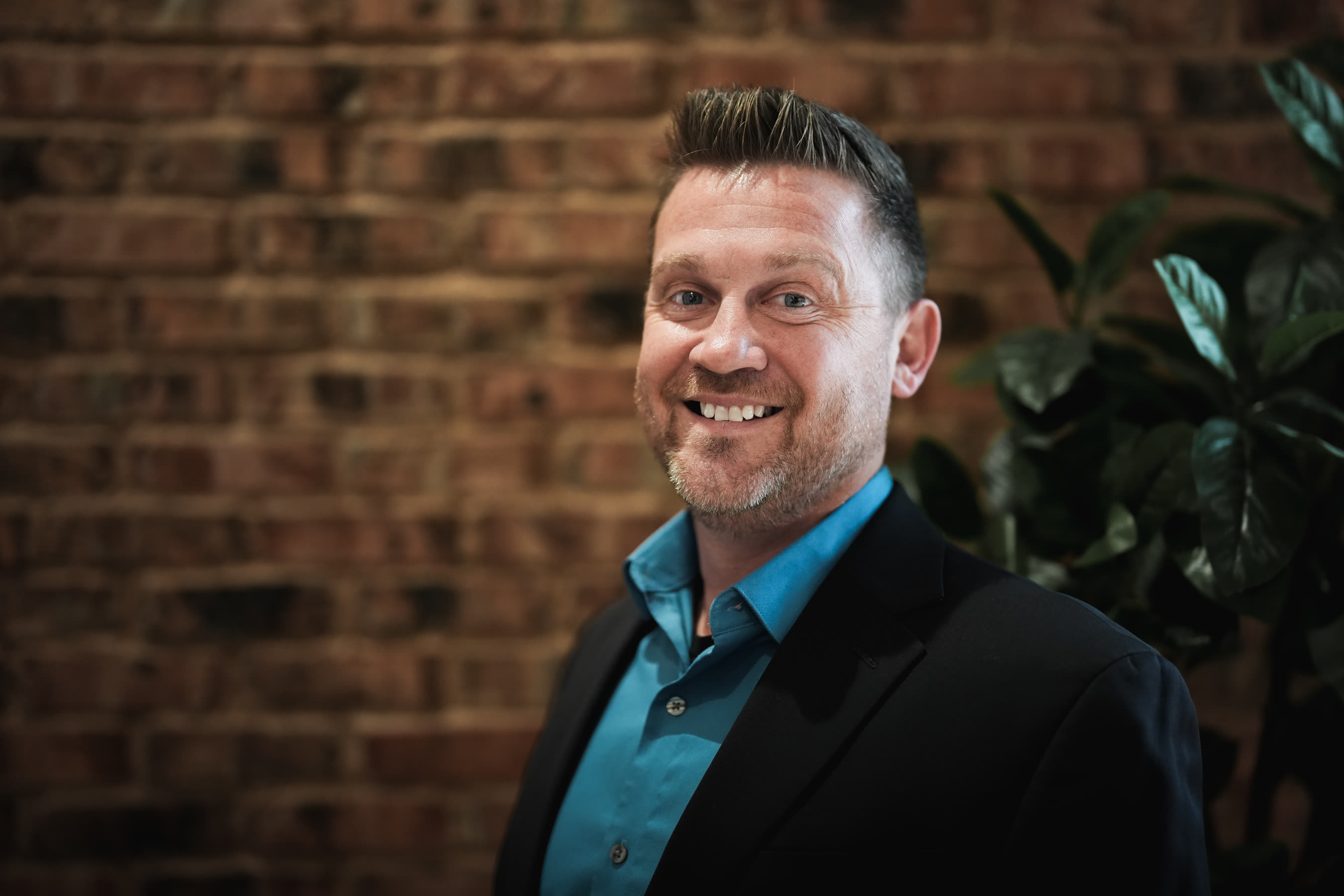 Business headshot against brick