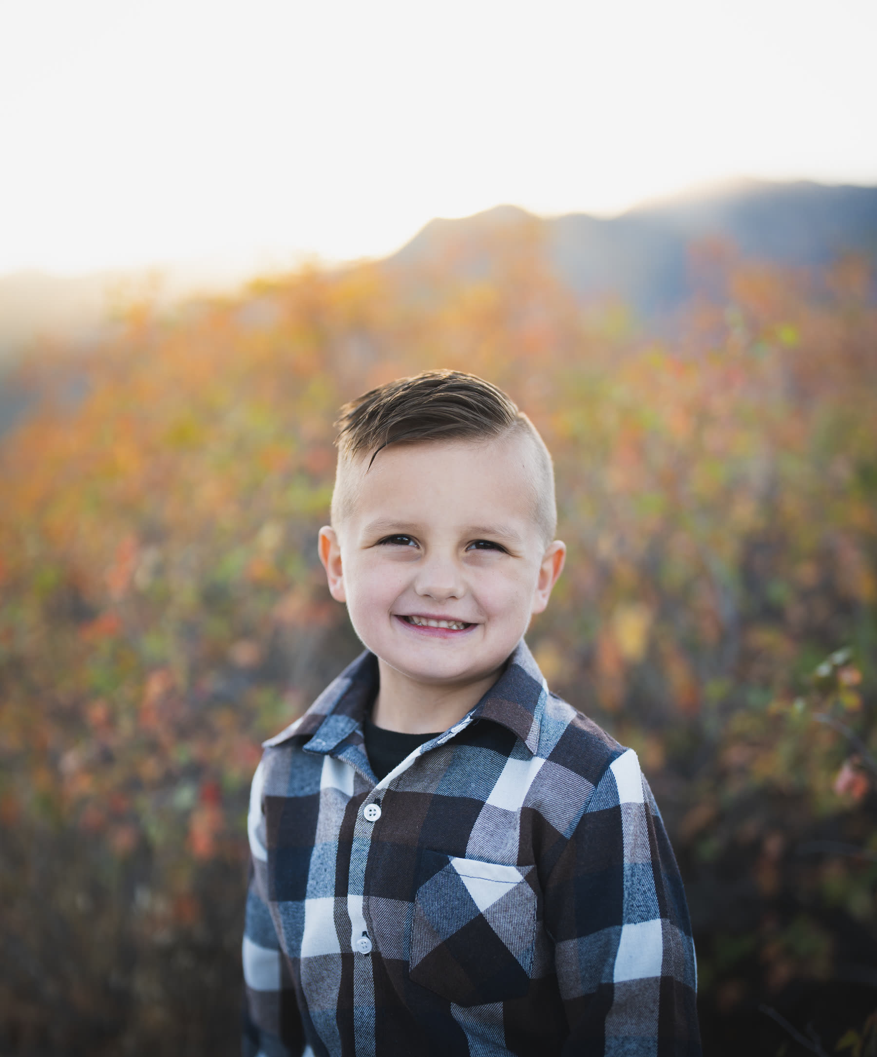 Child portrait, plaid shirt, fall colors