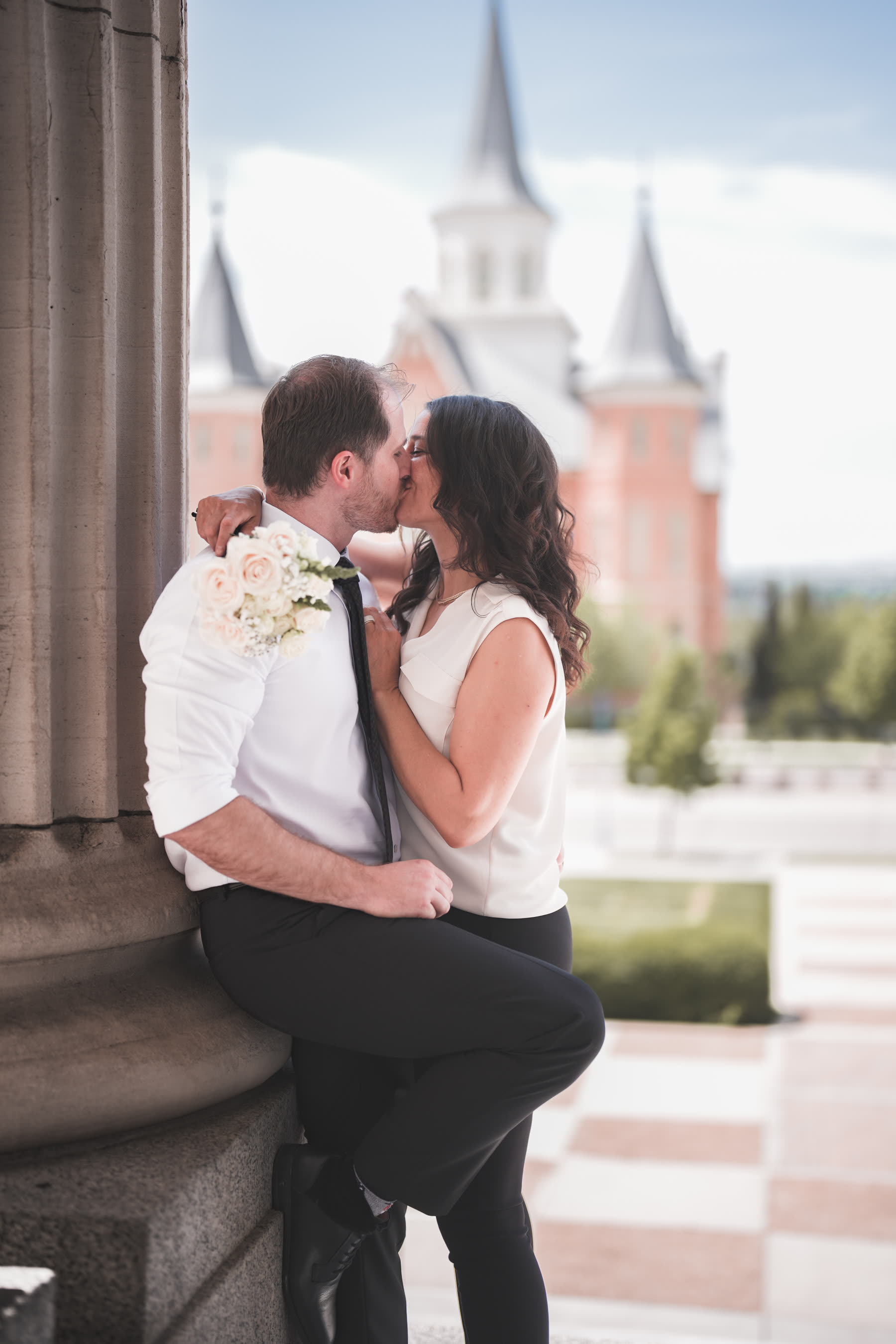 Bride and groom kissing at the temple