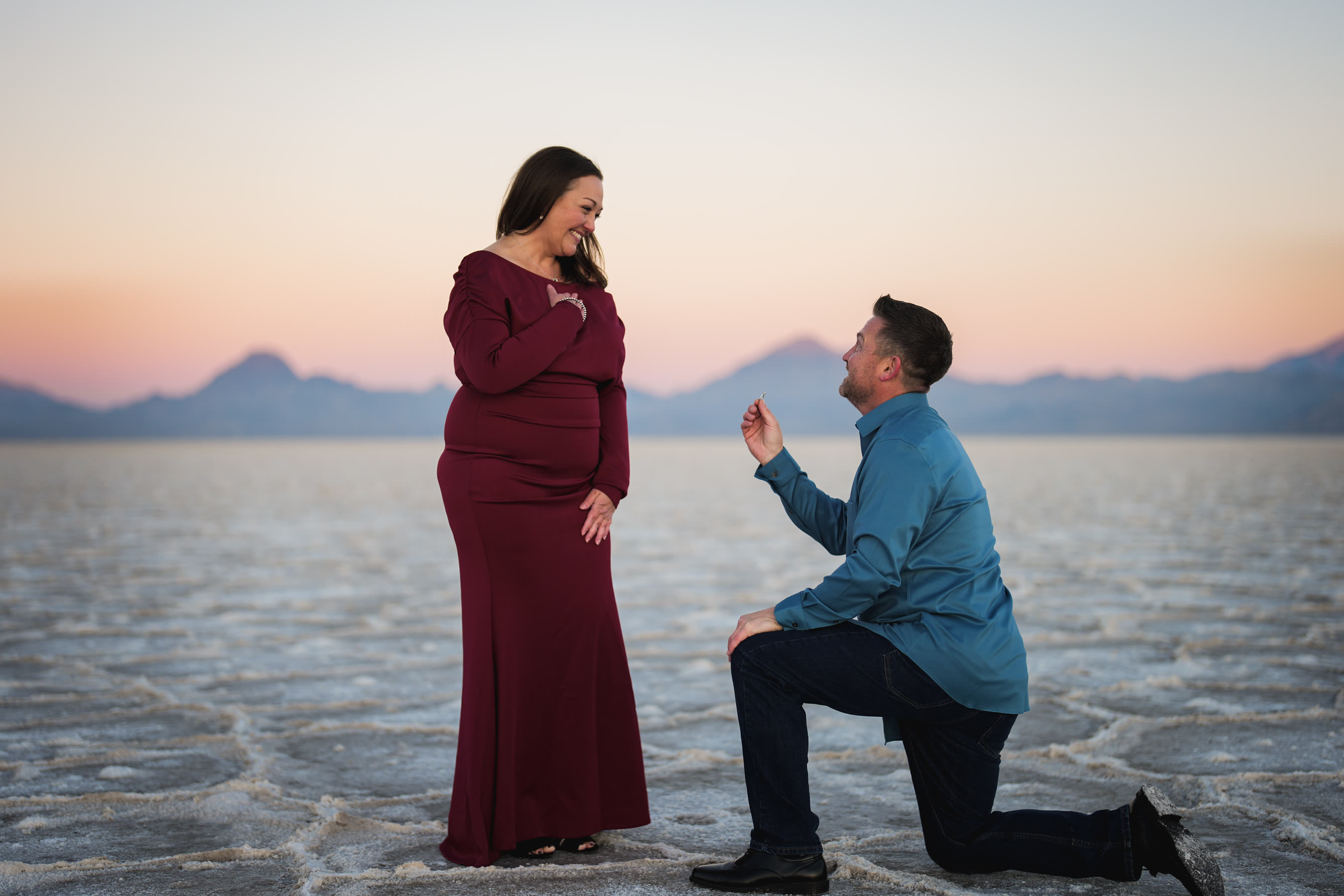Proposal on one knee at sunset by the lake