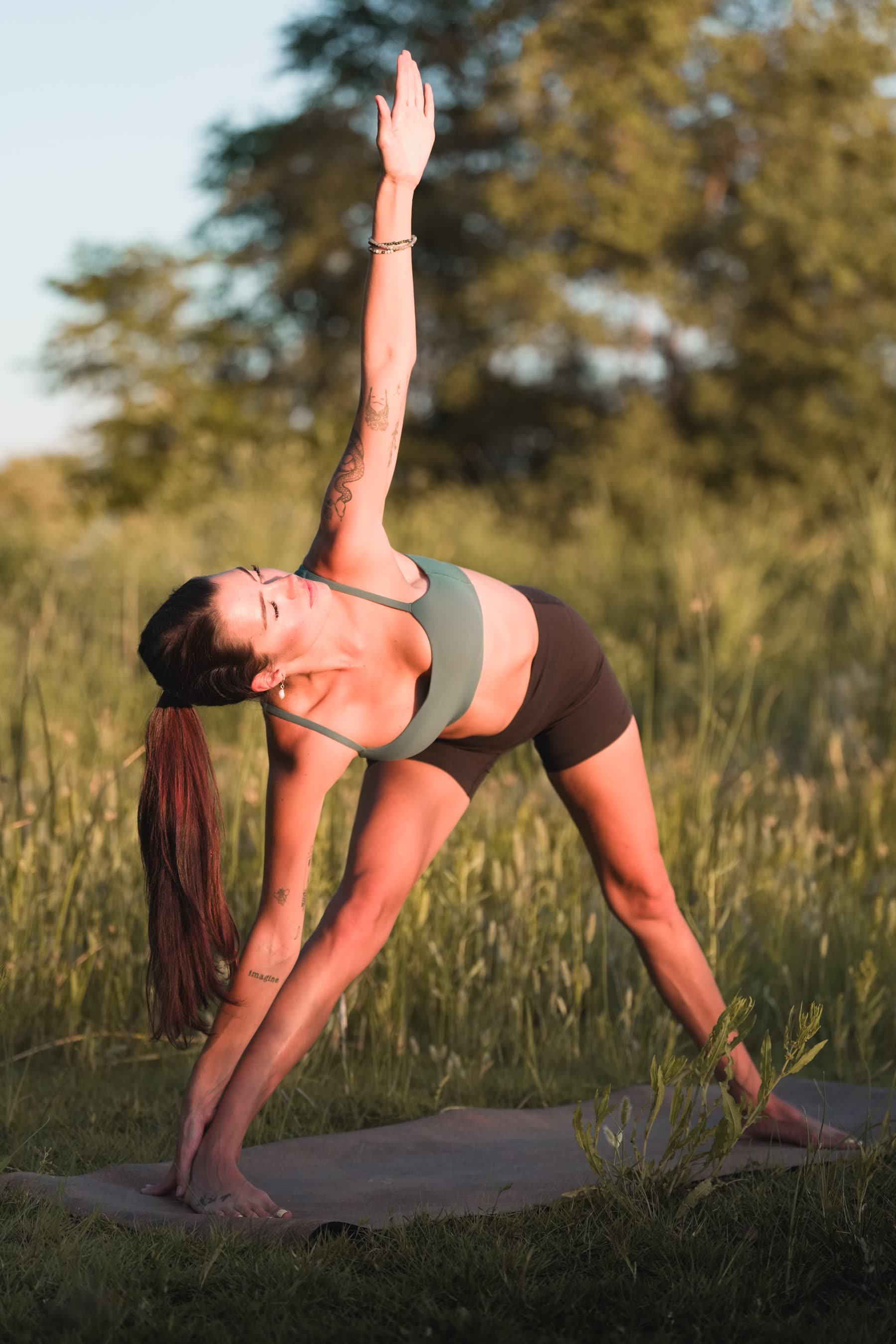 Yoga session, triangle pose at golden hour