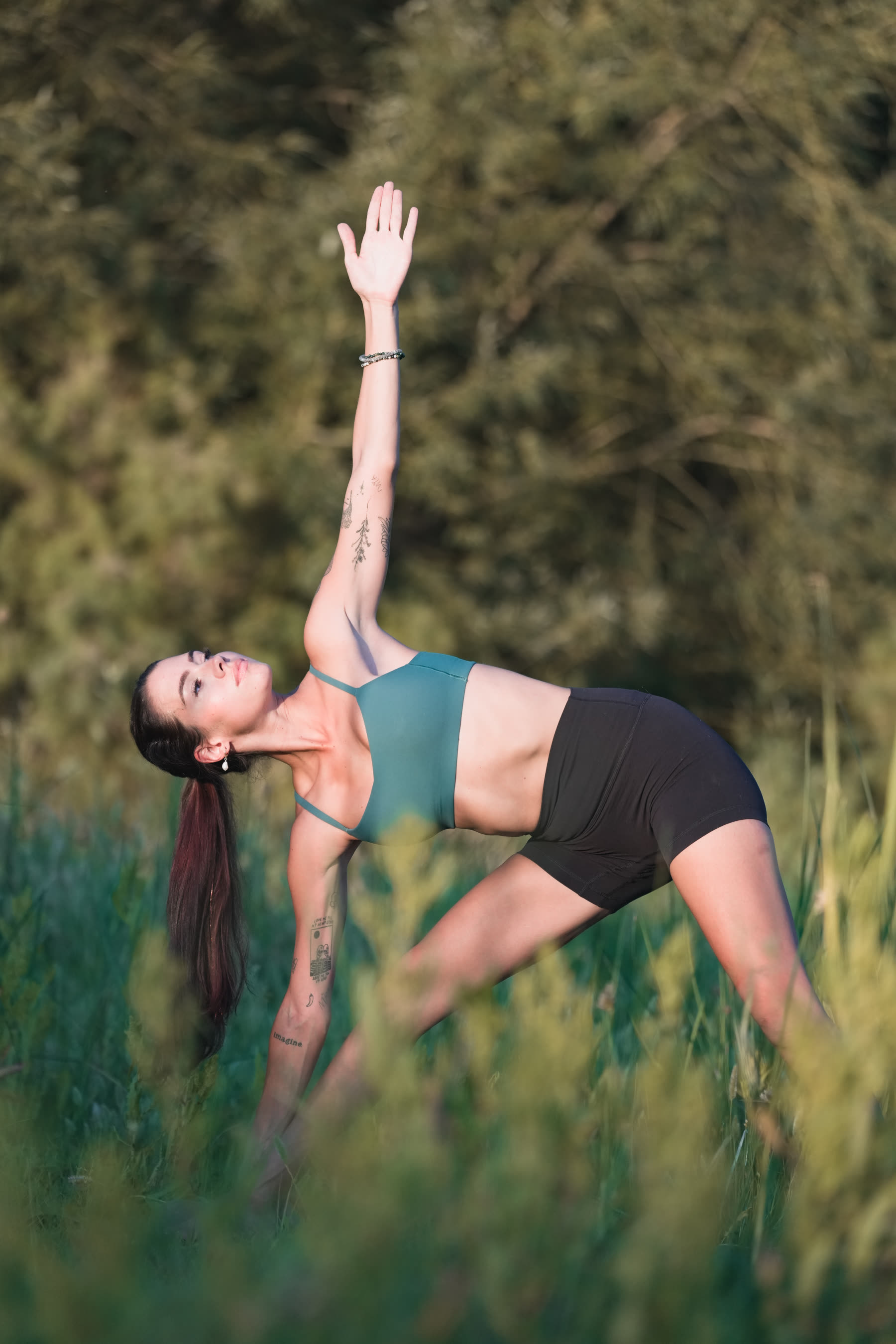 Yoga session, extended reach in tall grass